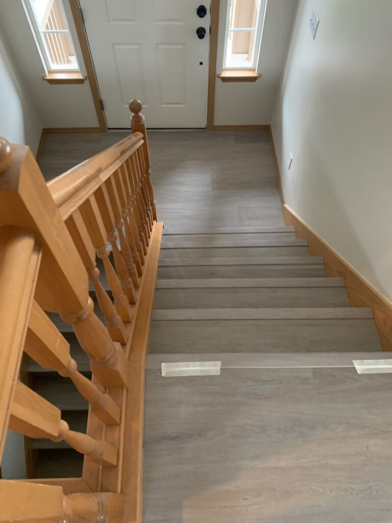Gray wood flooring. Carpet installers.