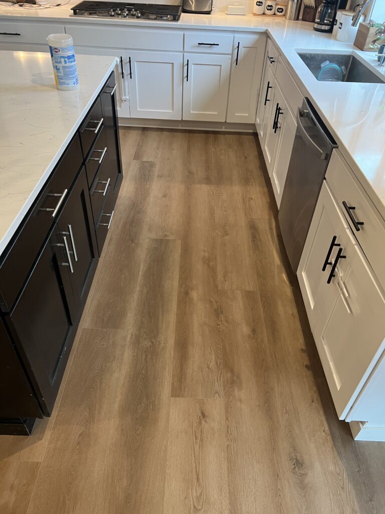 Light wood flooring in a kitchen. Home improvement. 